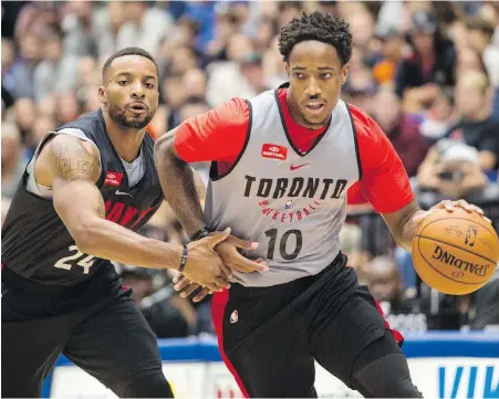  ??  ?? Raptors forward DeMar DeRozan tries to move the ball past Norman Powell during the NBA team’s intra-squad game at UVic’s CARSA gym on Thursday night.