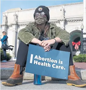  ?? LEIGH VOGEL GETTY IMAGES ?? A participan­t holds a sign during the Women’s “Hold the Line for Abortion Justice” march at Union Station in Washington on Wednesday .