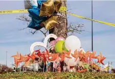  ?? Billy Schuerman / Associated Press ?? A memorial outside a Chesapeake, Va., Walmart honors victims after a store manager opened fire on employees, killing six.