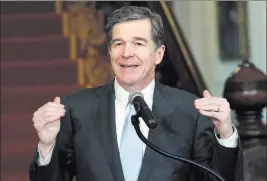  ?? CHRIS SEWARD/ ?? North Carolina Gov. Roy Cooper holds a news conference Thursday at the Executive Mansion in Raleigh, N.C., to announce that he signed HB142, a compromise replacemen­t bill for HB2, that the North Carolina General Assembly passed earlier in the day.