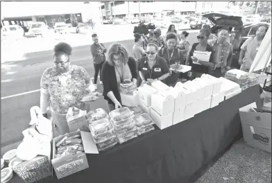  ?? AP Photo/Gregory Bull ?? Helping hands : Healthcare workers from UMC Hospital in Las Vegas, get free food on Tuesday. A gunman opened fire on an outdoor music concert on Sunday, with over 50 people killed and hundreds injured.