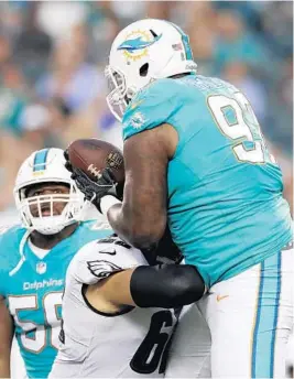  ?? YONG KIM/TNS ?? Defensive tackle Jordan Phillips, right, intercepts a pass over Eagles center Jason Kelce. Phillips returned the ball down to the 2 yard line.