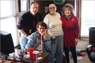  ?? Photo by Joseph B. Nadeau ?? The volunteers at WOON Radio helped increase the Milk Fund to an unexpected level of success while running the annual WOON Milk Fund Radio auction through Christmas Eve. From left are Robert Phillips, his wife Nancy on the telephone, Denise LePage, and Irene Blais.