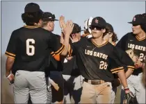  ?? NHAT V. MEYER — STAFF ARCHIVES ?? Los Gatos' Brayden Smith (28) high-fives teammate Sage Romero (6) after a win over Wilcox last season. Both are back after helping the Wildcats win the Santa Clara Valley Athletic League De Anza Division title by a whopping five games a year ago.