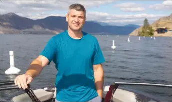  ?? GORD GOBLE/Special to the Herald ?? Bryan Wevers is shown with buoys that appear to have been illegally placed in Okanagan Lake in front of property owned by wine baron Anthony Von Mandl.