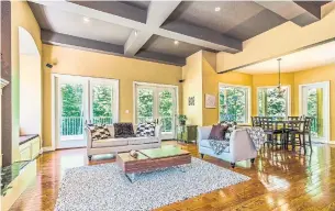  ?? COLDWELL BANKER — R.M.R. REAL ESTATE PHOTOS ?? The living room features hardwood floor and two double garden-door walkouts to the back deck.