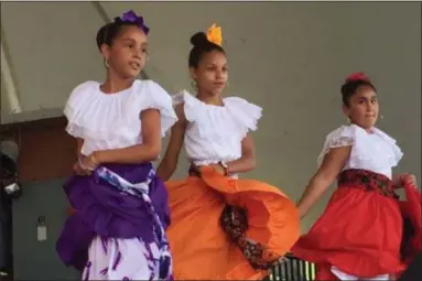  ?? KEVIN MARTIN — THE MORNING JOURNAL ?? Members of Puerto Rican dance group Esencia Boricua Cultural de Lorain perform on the main stage at Black River Landing on June 24 at the 51st annual Lorain Internatio­nal Festival. The group is in its 36th year of performing in the Internatio­nal...