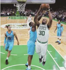  ?? AP PHOTO ?? SHOOTING FOR MORE: Guerschon Yabusele goes to the hoop during the Celtics’ victory Sunday night against the Charlotte Hornets at the Garden.