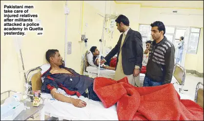  ?? AFP ?? Pakistani men take care of injured relatives after militants attacked a police academy in Quetta yesterday.