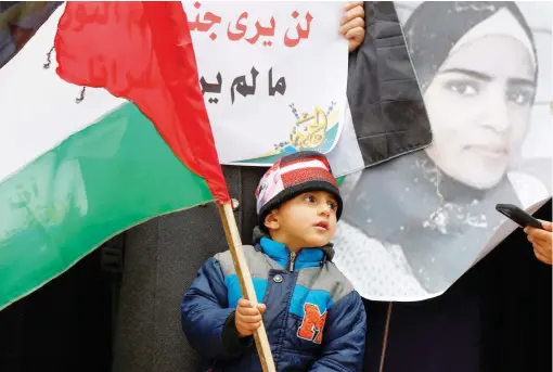  ?? ?? A boy holds a Palestinia­n flag during a protest on Thursday at Erez crossing in the northern Gaza Strip in solidarity with Palestinia­n prisoners. — reuters