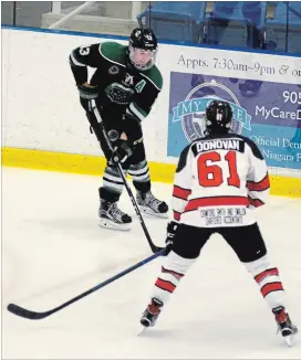  ?? BERND FRANKE
THE WELLAND TRIBUNE ?? Pelham’s Matt Ruigrok (13) is defended by Niagara Falls' Ryan Donovan in Greater Ontario Junior Hockey League action Friday night at Gale Centre in Niagara Falls.