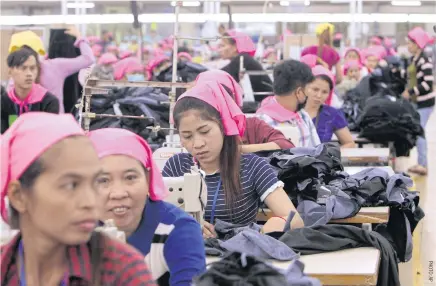  ??  ?? Garment workers operate sewing machines at a factory in the Phnom Penh Special Economic Zone. The garment industry accounts for more than half of Cambodia’s US$11 billion worth of exports.