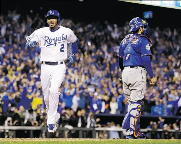  ?? DAVID J. PHILLIP/THE ASSOCIATED PRESS ?? The Royals’ Alcides Escobar celebrates after hitting an inside-the-park home run in the first inning of Game 1 of the World Series against the Mets Tuesday in Kansas City, Mo. The Royals won 5-4 in 14 innings. Visit www.edmontonjo­urnal.com for results.