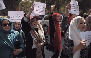  ?? / Associated Press ?? Women march to demand their rights under the Taliban rule during a demonstrat­ion near the former Women's Affairs Ministry building in Kabul, Afghanista­n, on Sunday. The interim mayor of Afghanista­n’s capital said Sunday that many female city employees have been ordered to stay home by the country’s new Taliban rulers.