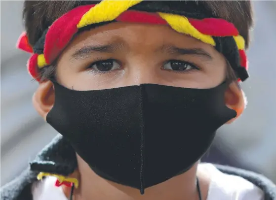  ?? Picture: RICHARD WAINWRIGHT/AAP IMAGE ?? A protester at a rally outside the Rio Tinto office in Perth earlier this month. The mining giant, under fire over damaging an ancient Aboriginal heritage site, has launched a review of its operations in Western Australia and issued a formal apology.