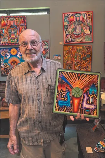  ?? AP FILE PHOTO ?? Gallery owner Mayer Shacter holds a Huichol yarn painting, at Galeria Atotonilco near San Miguel de Allende, Mexico in June.
