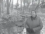  ?? ?? Laura Fay, chairperso­n of the science committee for Friends of the Lower Olentangy Watershed (FLOW), stands on Walhalla Road next to the stream that runs through Walhalla Ravine. The city of Columbus is in the midst of designing a $1 million fix that involves mitigation of sanitary-sewer overflow and helping eliminate pollutants in the water.