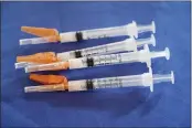  ?? ROGELIO V. SOLIS — THE ASSOCIATED PRESS ?? Syringes loaded with the Pfizer COVID-19vaccine lie ready for use by a nurse, in Jackson, Miss.