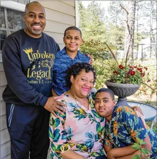  ??  ?? Earl McCarthy with his wife, Natasha Pierre McCarthy, and children Joshua, 12, (left) and Aidan, 14, at their home in southwest Atlanta. (Their oldest daughter is away at college.) Earl, who lost his job at the beginning of the pandemic, starts a new sales position next week.