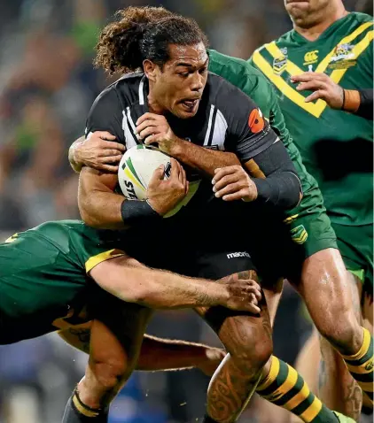  ??  ?? New Zealand’s Adam Blair is wrapped up by the Australian defence during the Anzac test.