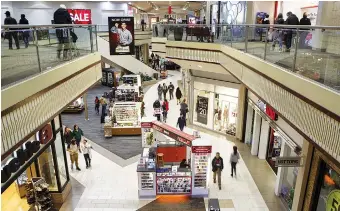  ?? STAFF PHOTO BY C.B. SCHMELTER ?? Shoppers move about Hamilton Place mall on Dec. 20.