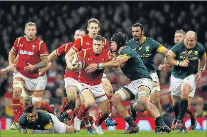  ?? Picture: GETTY IMAGES ?? CHARGE OF THE WELSH BRIGADE: Gareth Davies of Wales is tackled by Warren Whiteley of South Africa during the match on Saturday at Principali­ty Stadium, Cardiff. Wales won 27-13