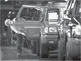  ?? LARRY MCCORMACK/THE TENNESSEAN ?? A worker does a final inspection of the door on an Xterra after it came off the production line at Nissan’s Smyrna plant in 2000.