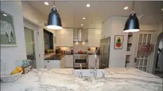  ?? Pam Panchak/Post-Gazette ?? Danby marble and soapstone counters and a Bertazzoni dualfuel range are features of a Squirrel Hill kitchen designed by Iliya Jordanoff.