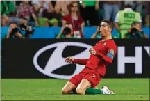  ?? ASSOCIATED PRESS MANU FERNANDEZ/THE ?? Ronaldo celebrates after scoring his second goal of the game during the Group B match against Spain on Friday in Sochi, Russia.