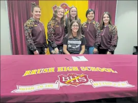 ?? Jack Harvel / The Fort Morgan Times ?? Brush High School first baseman and catcher Kylei Abreo is surrounded by teammates as she signs to play with Crown College starting in 2021.