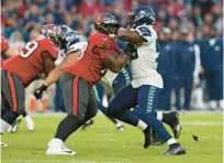  ?? STEVE LUCIANO/AP ?? Bucs offensive tackle Tristan Wirfs, left, battles against Seahawks linebacker Boye Mafe during the teams’ game at Allianz Arena in Munich, Germany, in November.