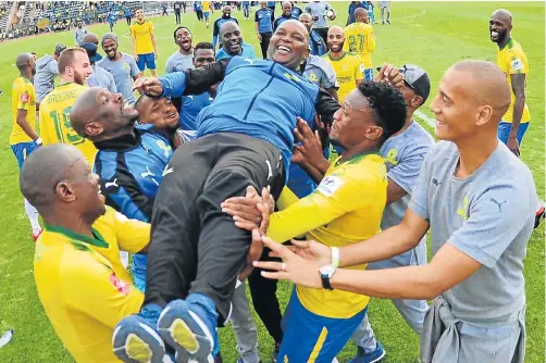  ?? Picture: LEFTY SHIVAMBU/GALLO IMAGES ?? ALL HAIL THE COACH: Mamelodi Sundowns coach Pitso Mosimane celebrates with his players after their victory in the Absa Premiershi­p match against Ajax Cape Town at the Lucas Moripe Stadium in Pretoria