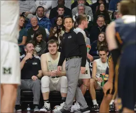  ?? OWEN MCCUE — MEDIANEWS GROUP ?? Methacton coach Jeff Derstine, center, smiles on the sidelines as he watches Owen Kropp shoot a free throw late during the District 1-6A championsh­ip game against Cheltenham on Saturday, Feb. 29, 2020.