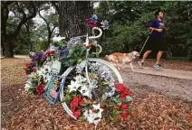  ??  ?? Flowers adorn a memorial for Marjorie Corcoran, who died Feb. 3, 2017, at the intersecti­on. Also killed there April 24 was Sudipta Roy. The city is working on a long-term safety plan.