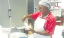  ?? Picture: GUY ROGERS ?? MELTING AWAY: Il Gelato supervisor and master ice-cream maker Thandi Lamani has to contend with power cuts