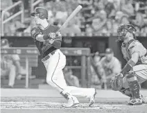  ?? MARK BROWN/GETTY IMAGES ?? In Saturday’s game, Brian Anderson of the Miami Marlins doubles for an RBI in the first inning.