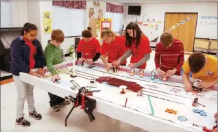  ?? SUBMITTED ?? The First Lego League of Central Magnet Elementary School works on setting up the course for the league’s robot to complete 15 missions. From the left are Enelyn Hernandez, Jacob Wolform, Lexie Rice, Allison Fredricks, Lauren McDaniel, Cody Tosh and...