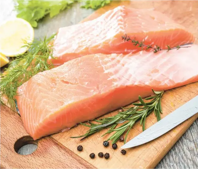  ?? DREAMSTIME ?? For this recipe, the salmon is coated with a mixture of honey and mustard.