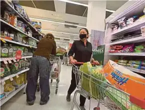  ?? AFP PIC ?? Residents stocking up on provisions at a shopping mall in Sydney yesterday.