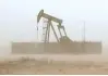  ?? — Reuters ?? A pump jack lifts oil out of a well, during a sandstorm in Midland, Texas, US.