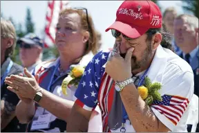  ?? ROBERT F. BUKATY — THE ASSOCIATED PRESS ?? John Biernacki of Greenville, Tex., wipes tears during the unveiling of a monument to honor military passengers of Flying Tiger Line Flight 739May 15in Columbia Falls, Maine. His father, M.Sgt. Henry Biernacki, was killed on the secret mission to Vietnam in 1962.