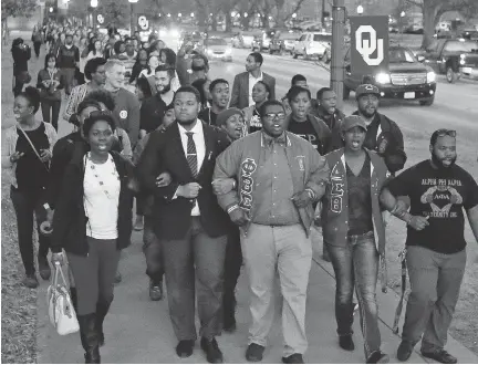  ??  SUE OGROCKI/THE ASSOCIATED PRESS ?? University of Oklahoma students march to the now closed University of Oklahoma’s Sigma Alpha Epsilon fraternity house during a rally in reaction to an incident in which members of a fraternity were caught on video chanting a racial slur.