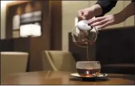  ?? Bloomberg News/AKIO KON ?? An employee serves tea to a customer at the View Gold Lounge operated by East Japan Railway Co. and View Card Co. at Tokyo Station last week.