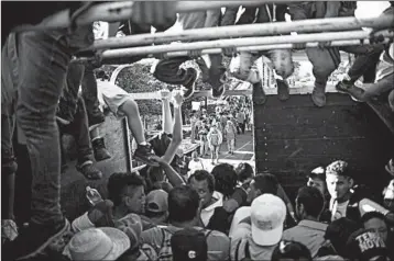  ?? PEDRO PARDO/GETTY-AFP ?? Honduran migrants head to the U.S. on Monday aboard a truck in Metapa, Mexico.