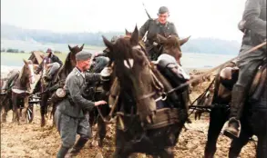  ?? ?? Polizei with their horses are struggling towing supplies along a muddy road