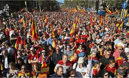  ?? — AP ?? Stay together: Nationalis­t activists marching during a mass rally against Catalonia’s declaratio­n of independen­ce, in Barcelona, Spain.