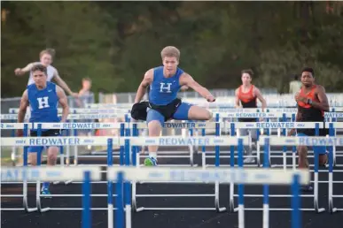  ?? Staff photo by Evan Lewis ?? n Hooks senior Jordan Baugh leads the 110 hurdles to the finish line Thursday evening at the Joe Culpepper Relay in Redwater, Texas.