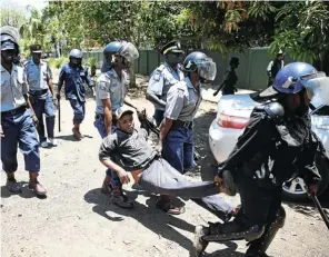  ?? Picture: Reuters/Philimon Bulawayo ?? TAKING IT LYING DOWN: Zimbabwean police carry away a protester during a march on government offices during a demonstrat­ion in Harare in 2019.