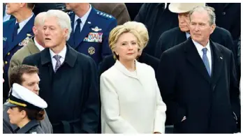  ??  ?? BELOW: Flanked by her husband, Bill (left), and another former president, George W Bush, Hillary puts on a brave face at Trump’s presidenti­al inaugurati­on earlier this year.