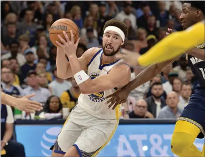  ?? BRANDON DILL — THE ASSOCIATED PRESS ?? Warriors guard Klay Thompson (11) drives against Grizzlies forward Jaren Jackson Jr. (13) during the first half of Game 2on Tuesday.